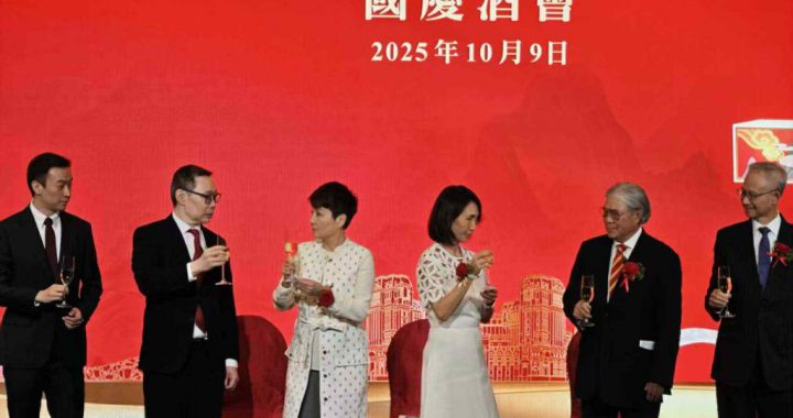 主礼嘉宾与管理层于国庆酒会台上举杯合影（红色主视觉背景）