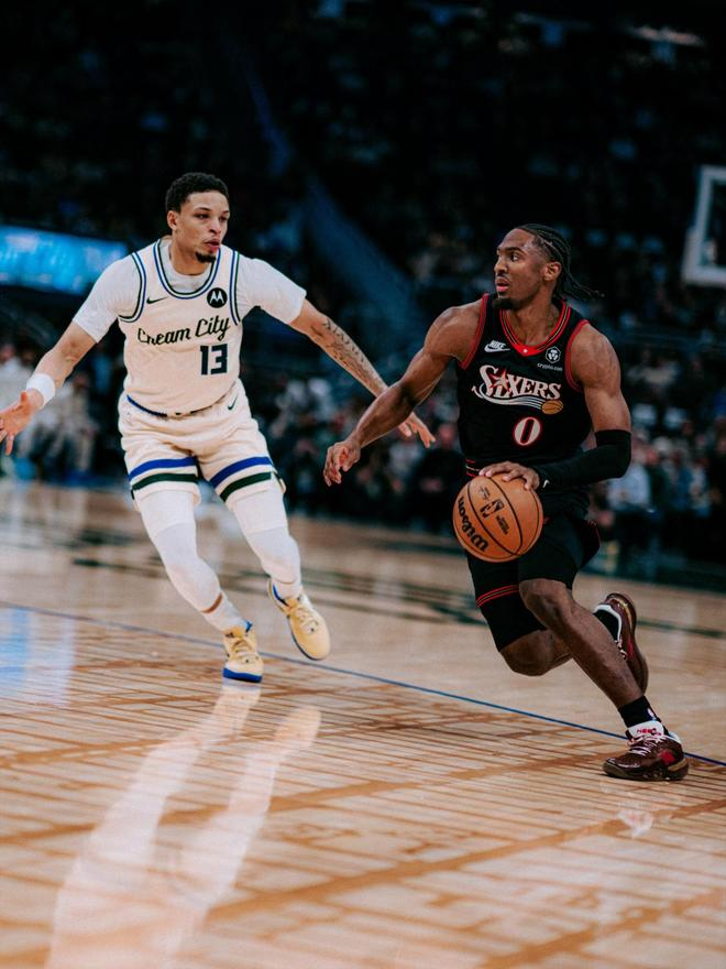 76人后卫马克西突破雄鹿球员罗林斯的单打画面