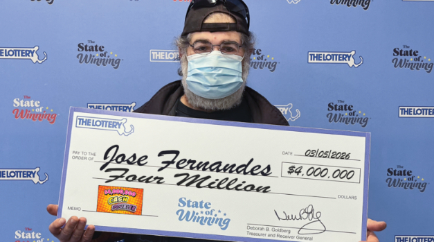 男子手持400万美元彩票大奖支票领奖现场