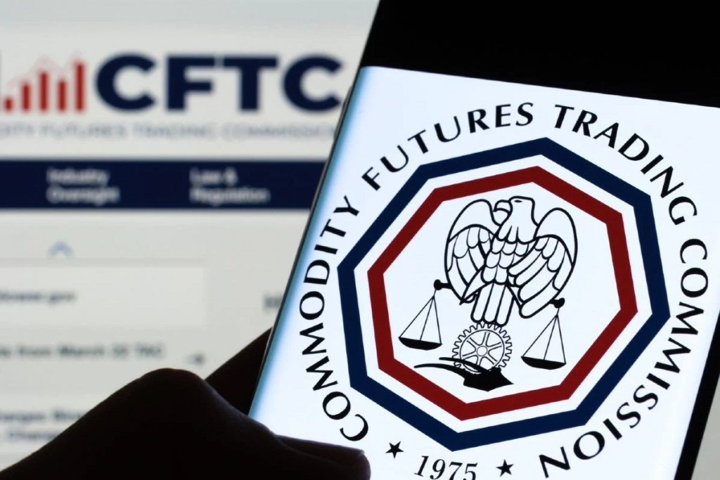 手机画面显示美国商品期货交易委员会CFTC标志，象征农业团体要求监管机构审查预测市场农产品事件合约